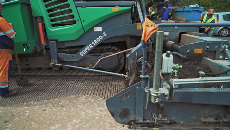 road construction and street repair background. industrial pavement truck laying fresh asphalt on construction site