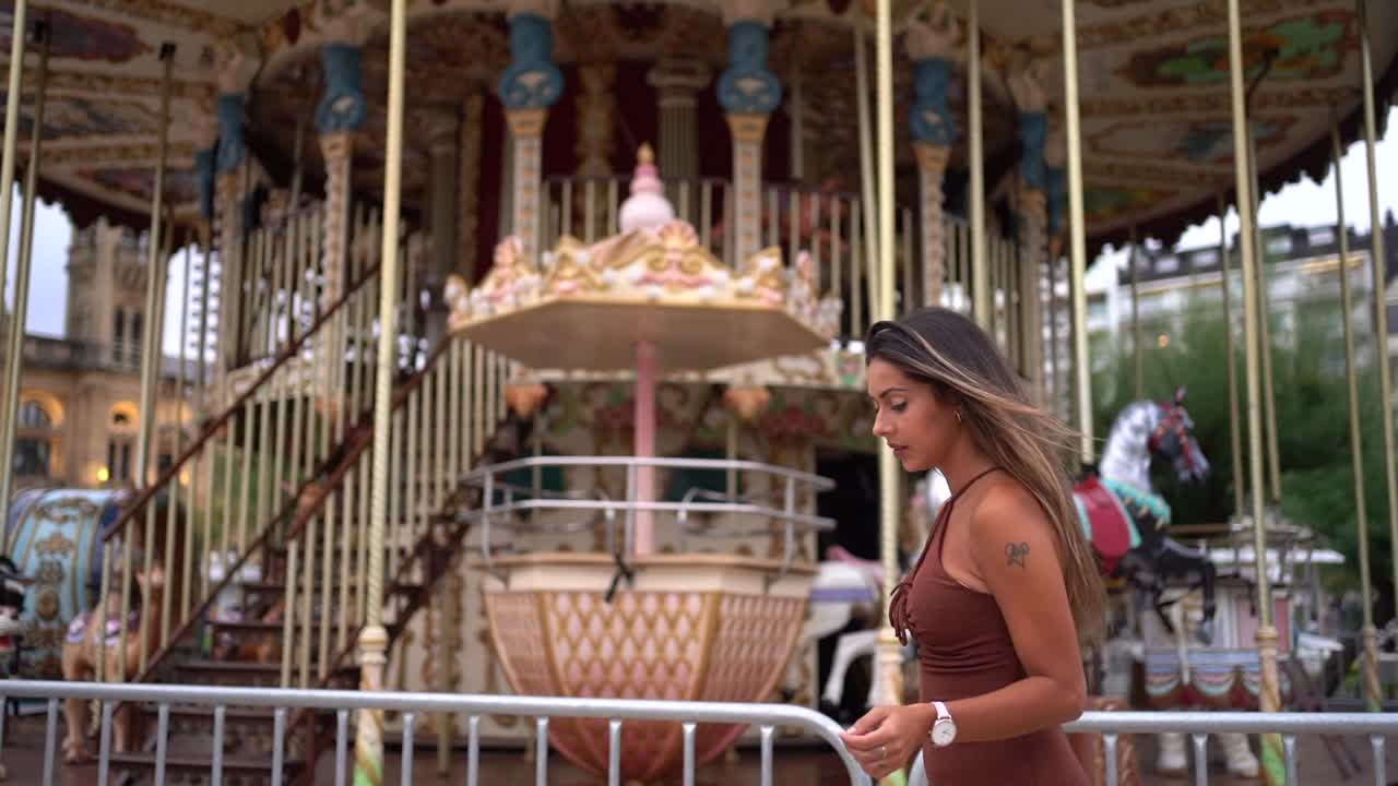 Woman in dress near carousel