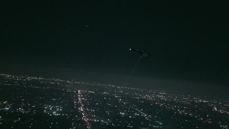 police helicopter circles downtown la with search light looking for escaped prisoner during a manhunt