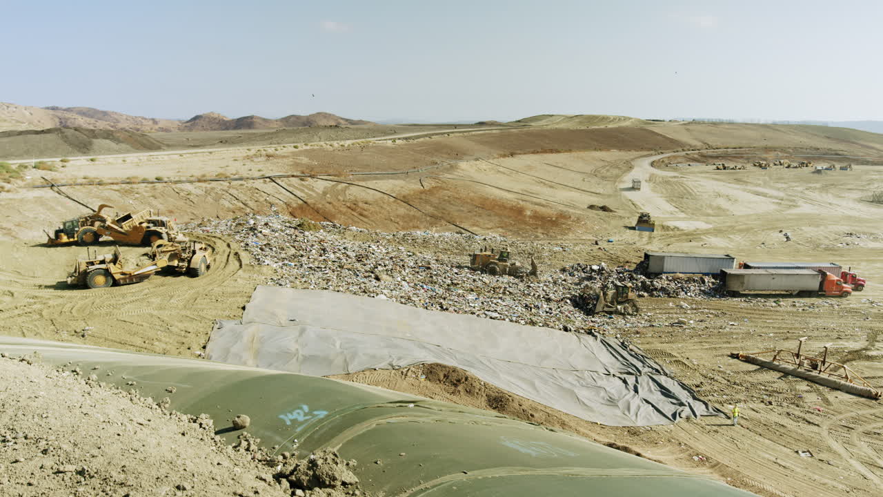 Large Landfill with Heavy Machinery and Waste