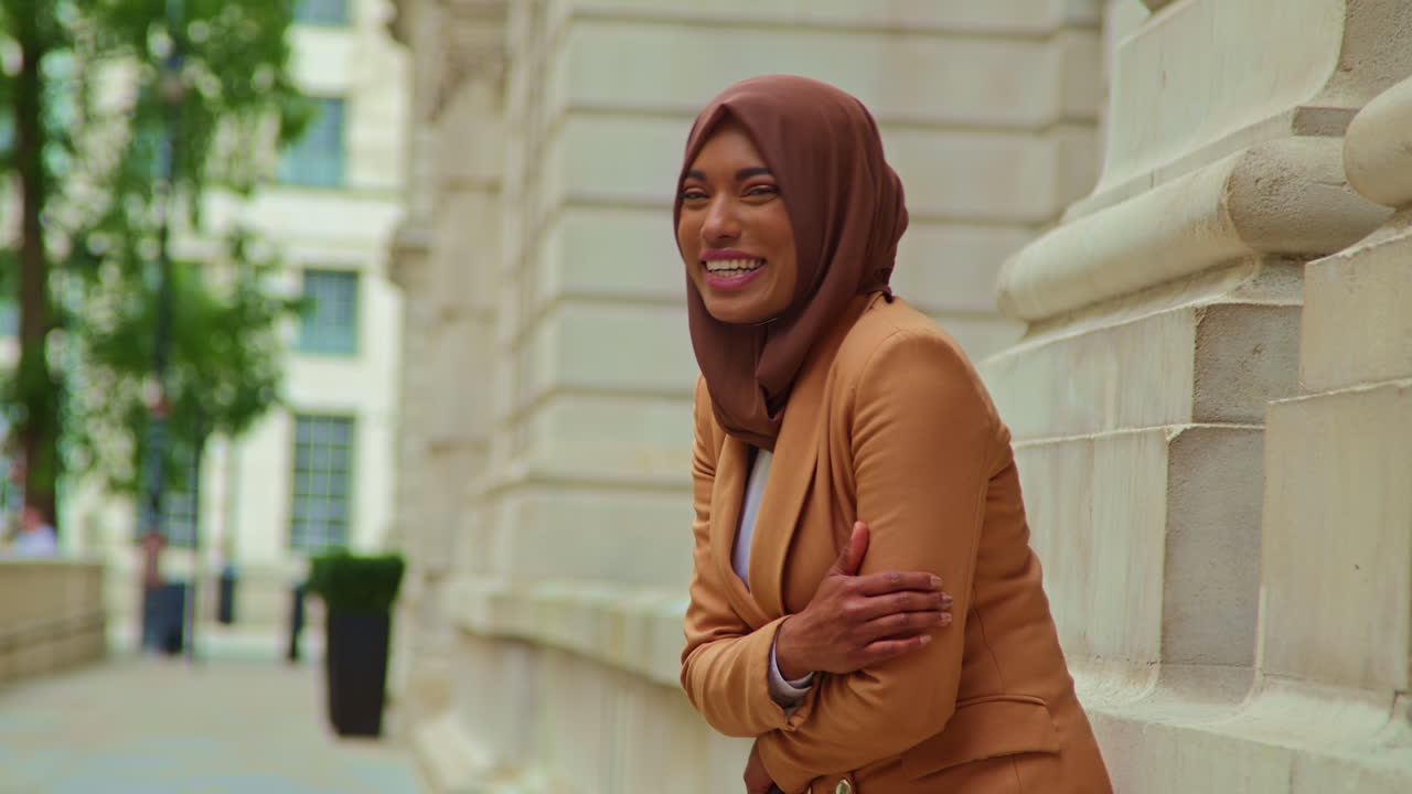 Portrait Of Smiling Muslim Businesswoman Wearing Hijab And Modern Business Suit Standing Outside City Office Buildings 4