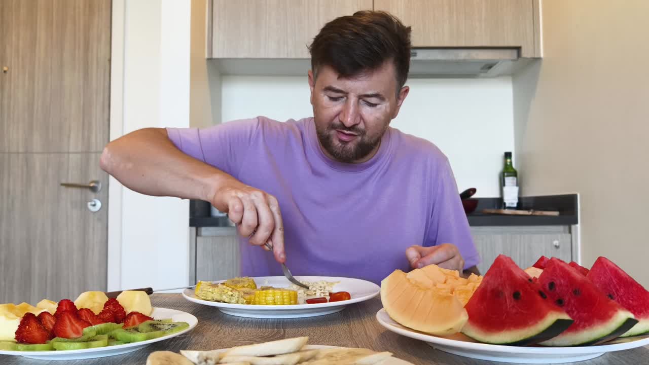 Man eating a healthy fruit and corn breakfast