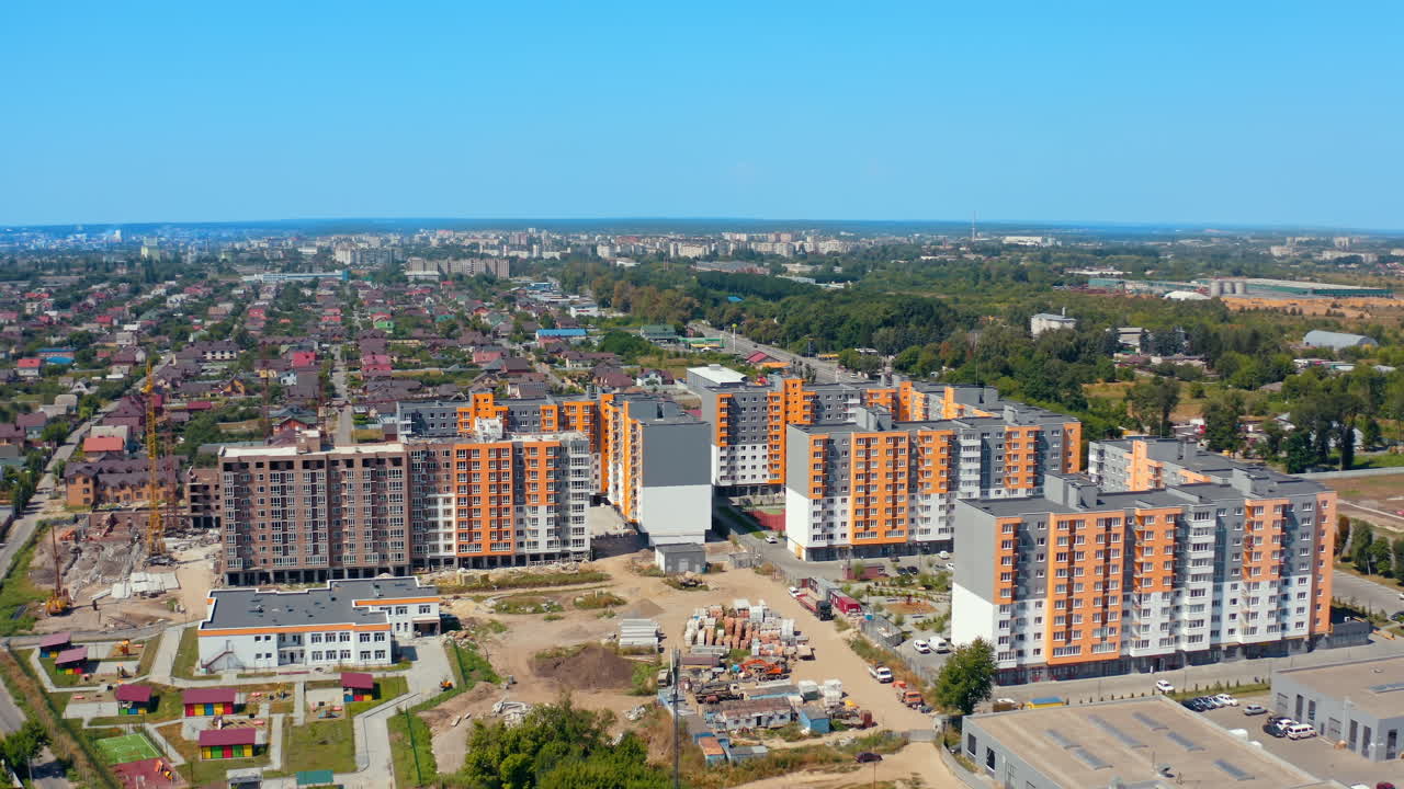 New housing apartments on urban background. Residential complex with high-rise buildings in new city area. Aerial view.