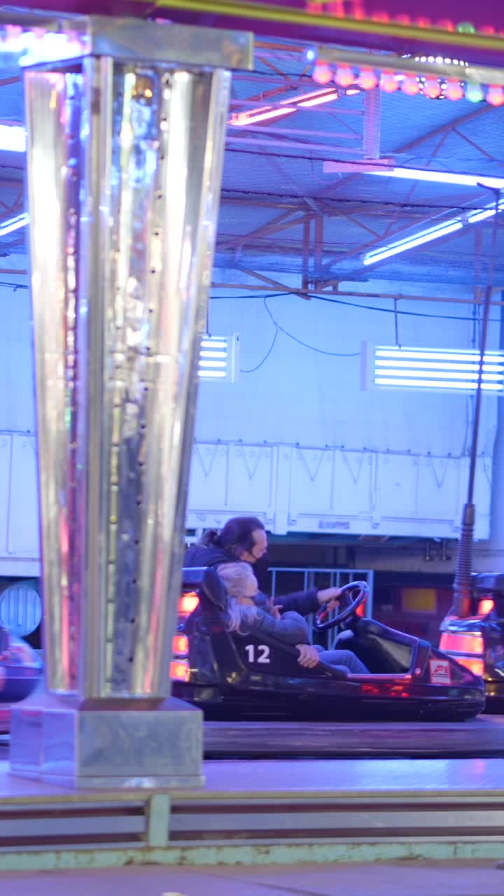 People Enjoying Bumper Car Rides at a Fair