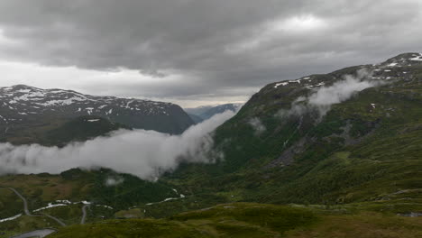 Fog-Rolling-Down-The-Mountain-Pass-Landscape-In-A-Small-Village-Of-Fortun,-Vestland-County,-Western-Norway