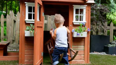 baby boy playing with chair in play house 4k