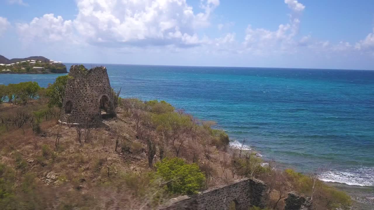 Drone view of Old Sugar Cane mill in Antigua Caribbean Islands with sea in background