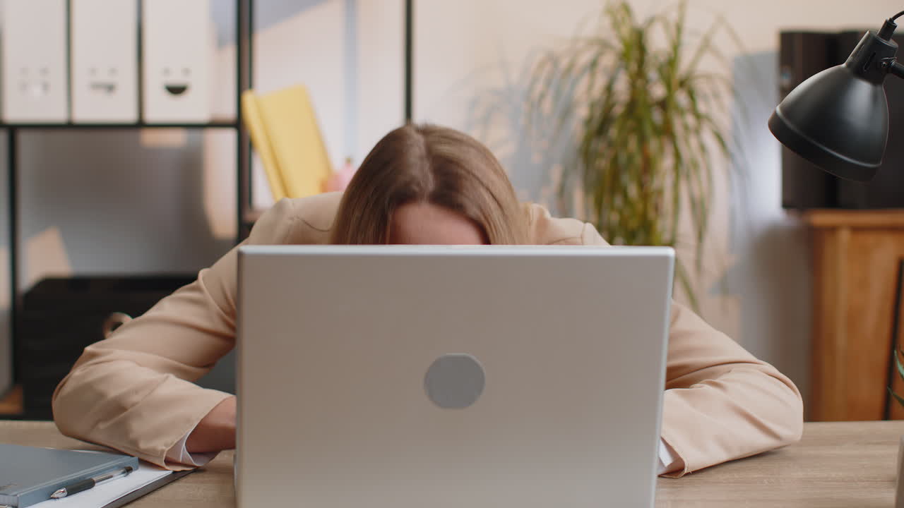 Office businesswoman hiding behind laptop computer make funny silly face fooling around disrespect