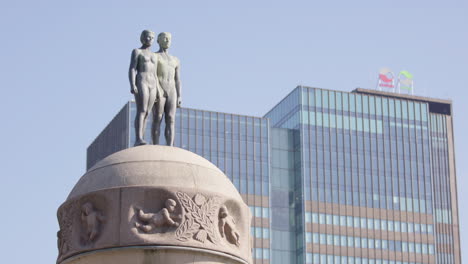 wide shot of ornulfs bronze sculpture by central station in oslo, sunny summer