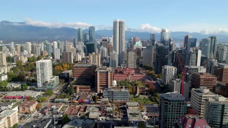 west end neighborhood with skyline of downtown vancouver in bc, canada. - aerial shot