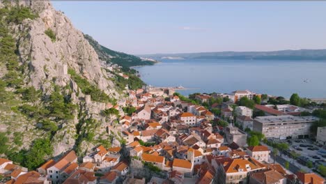 european medieval old town of omis, croatia, aerial dolly out, summer sunrise