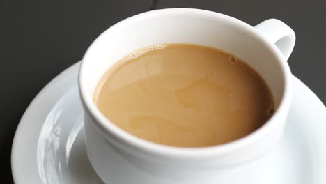 pouring brown sugar in a coffee cup