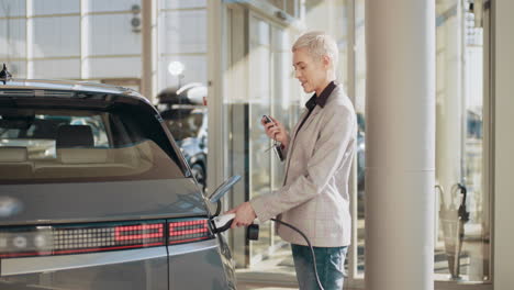 woman charging an electric car