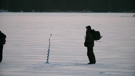 winter scene, men walking on ice for winter fishing in arctic frost, slow motion