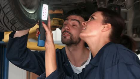 Mechanics-looking-at-a-tire