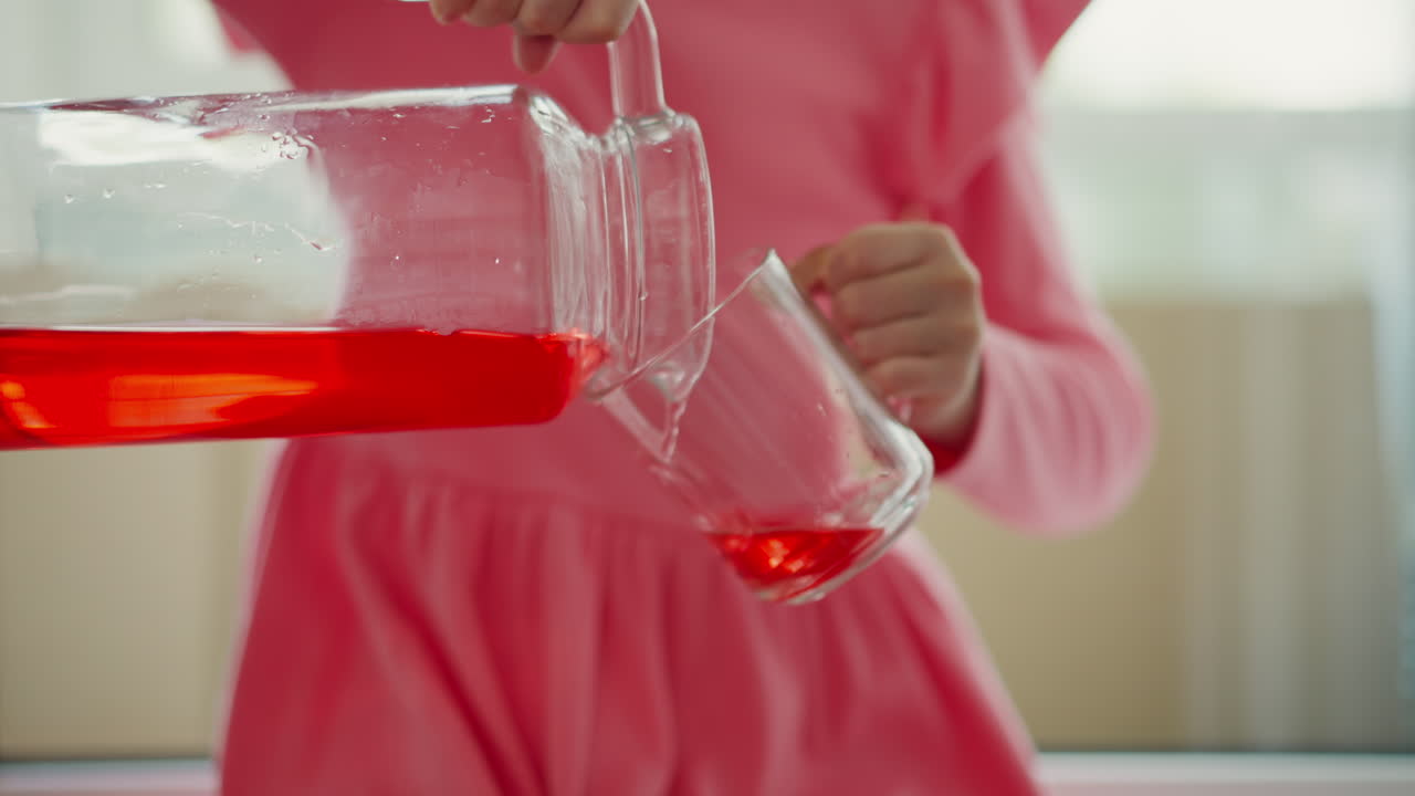 Girl pouring juice into a glass