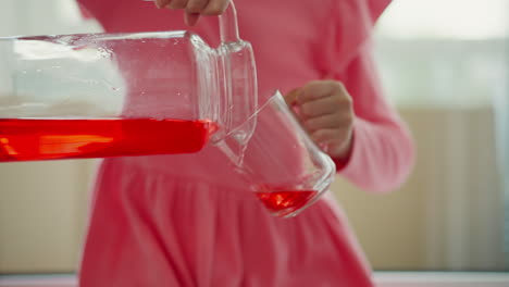 girl pouring juice into a glass