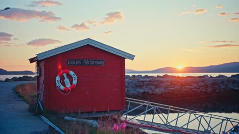 A Peaceful Sunset Casts Warm Light Over the Kokelv Boat Association by the Shore in Kokelv, Norway - Close Up