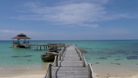 POV-Walking-on-wooden-footbridge-that-leads-to-the-sea