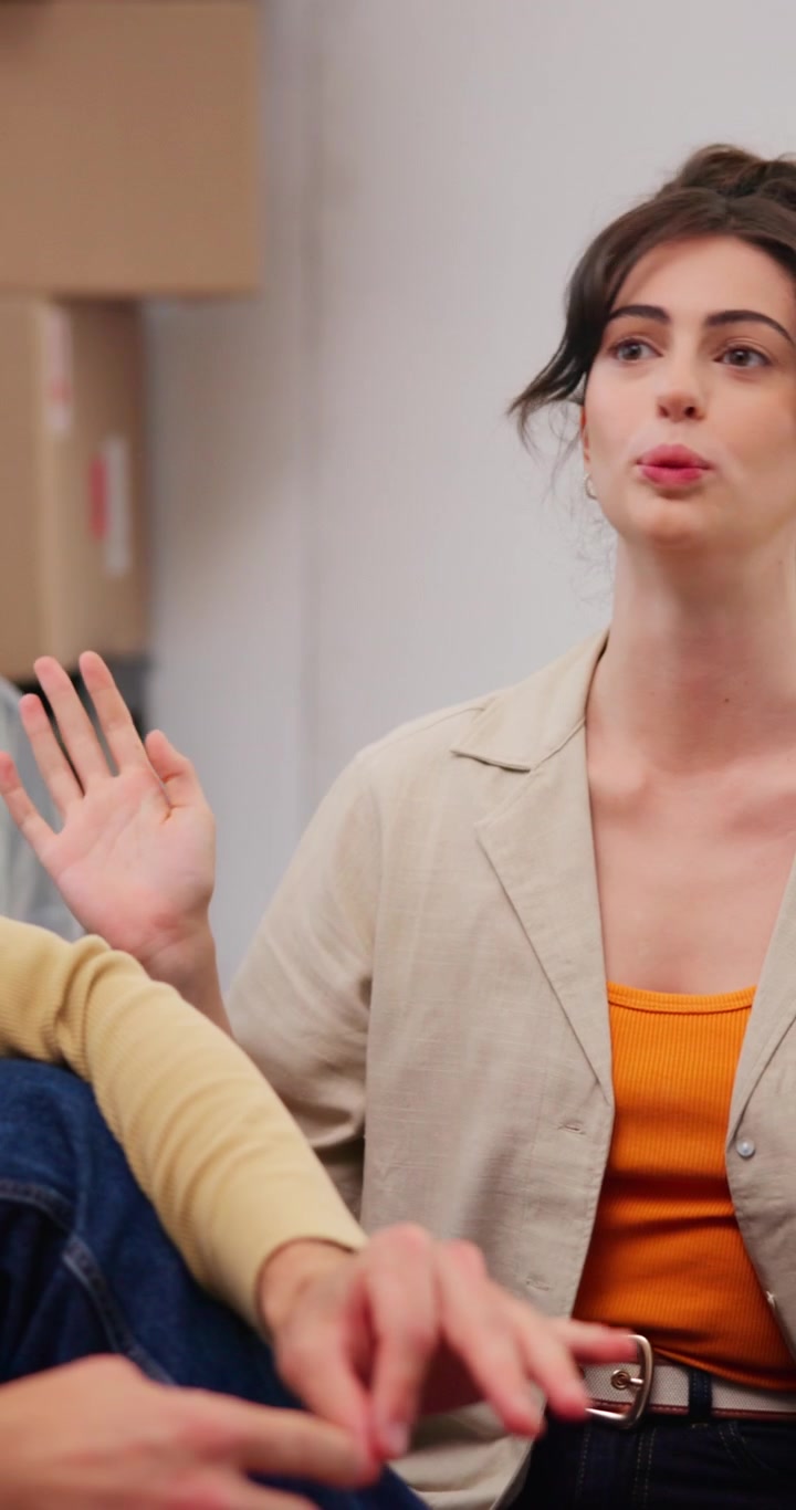 Young Woman Talking and Gesturing During Conversation in New Home