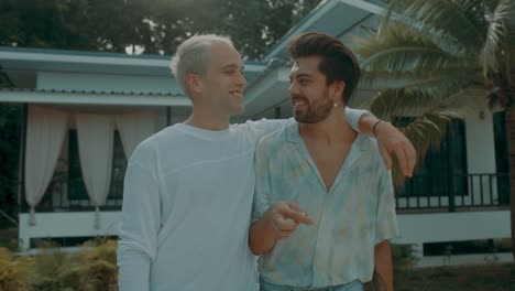 happy gay couple at tropical home
