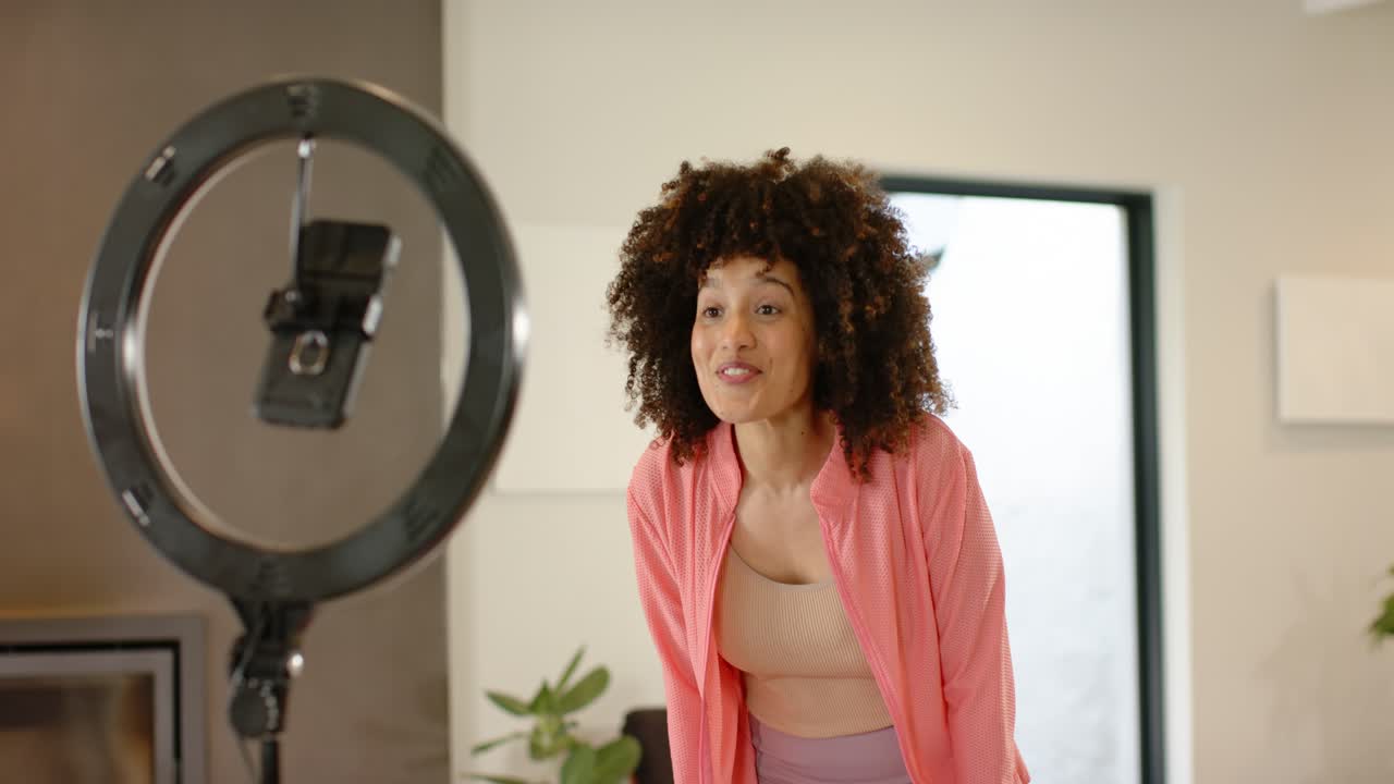 African American woman at home clapping greeting viewers transitioning into gesturing by ring light
