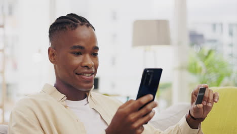 Phone,-credit-card-and-black-man-online-shopping