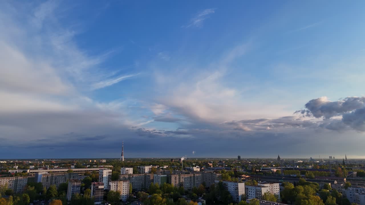 Beautiful cityscape of Riga under a dramatic cloudy sky, capturing light and texture in the skyline.
