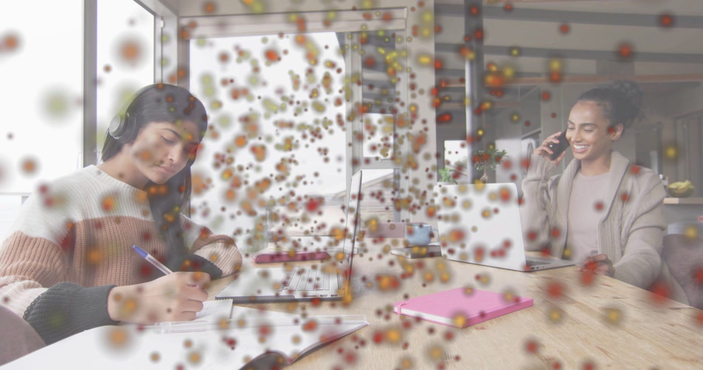 Mother and daughter using laptop smartphone for study while bright particles appearing across frame