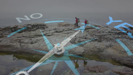 Couple hiking rugged shoreline, using animated navigation compass overlay showing YES and NO arrows