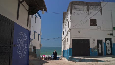 Woman-walking-in-Taghazout-village-Morocco