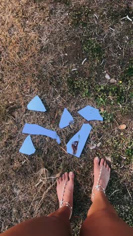 broken mirror reflection on grass