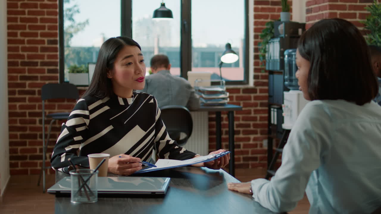 HR employee greeting female applicant at job interview