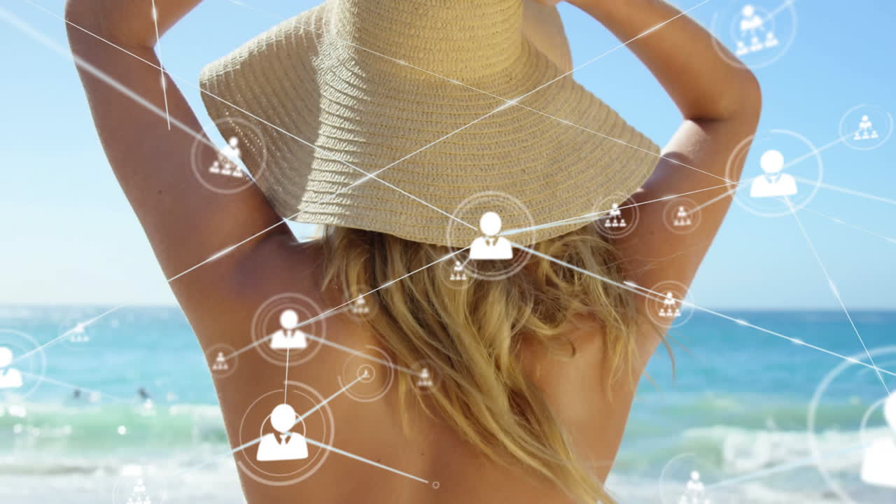 Wearing sun hat at beach, person with animation of social media icons