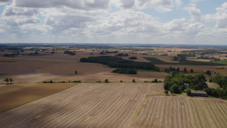 aerial panoramic view of vast farmland near countryside against beautiful cloudscape sky