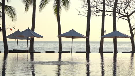 a golden glow reflects in a resort swimming pool