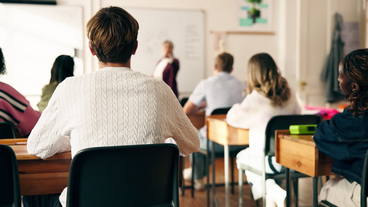 Students in a classroom learning from a teacher