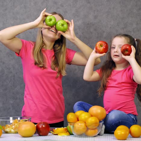mother and daughter with fruit