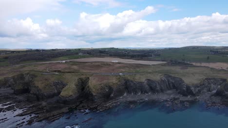 Dramatic-and-wild-coastal-area-of-Galley-Head-view-point,-an-aerial-backwards-flight-revealing