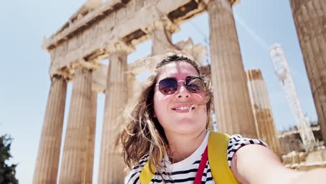 happy woman's selfie at the parthenon in athens, greece