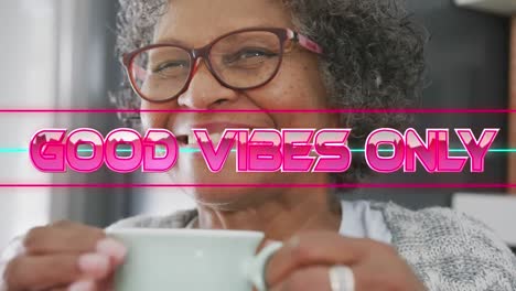 Animation-of-good-vibes-only-text-over-senior-woman-drinking-tea-and-smiling-at-home