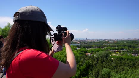 tourist woman photographing beihai park from prospect hill, beijing