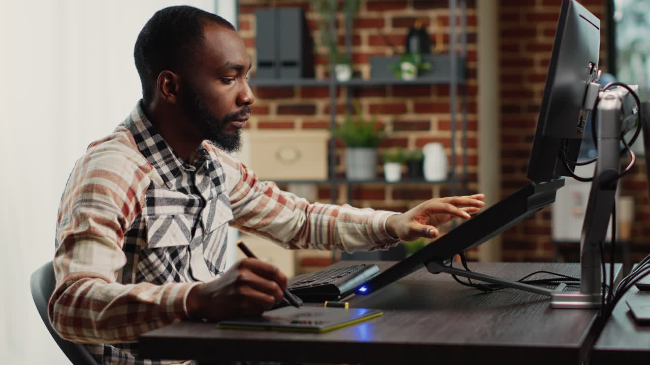 African american expert smiling and working with graphic tablet