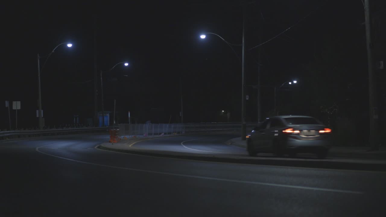 Lone Car Passing By The Street Road Late At Night In Canada - Medium Shot (Static)
