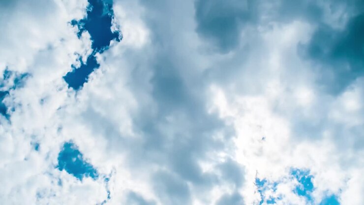 Time lapse of cloudscape with bright sun shining and revealing itself behind clouds