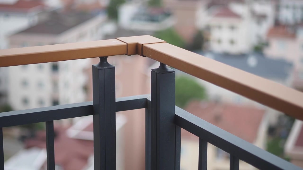 Close-up of a Modern Balcony Railing with Blurred City Background