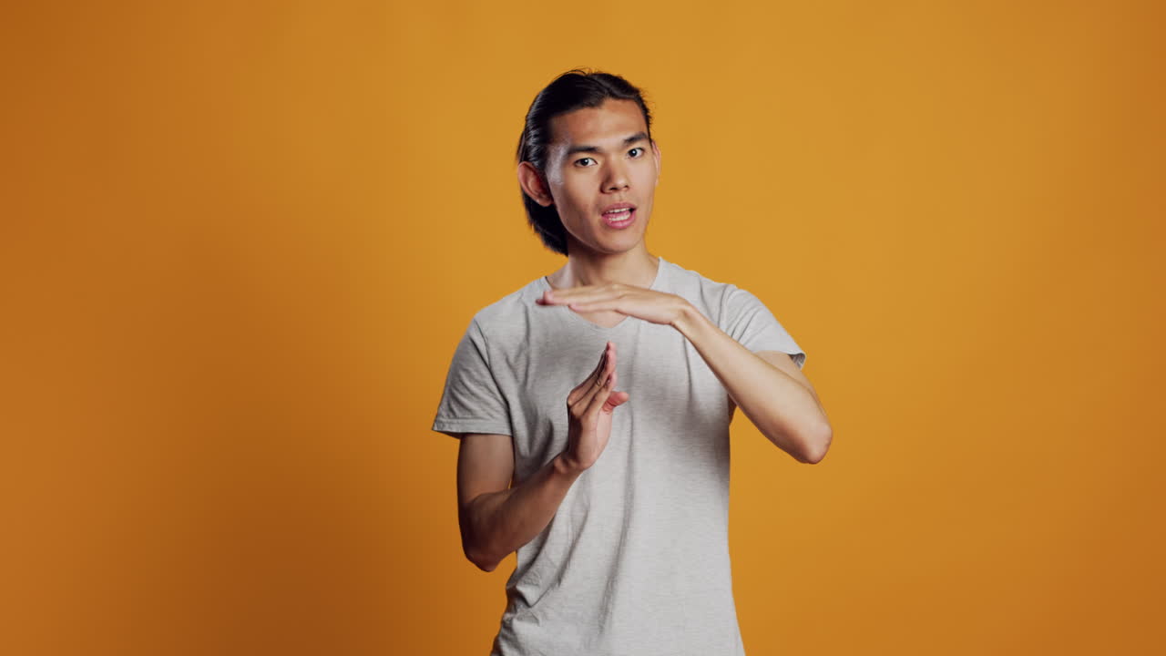 Young adult doing t shape symbol on camera