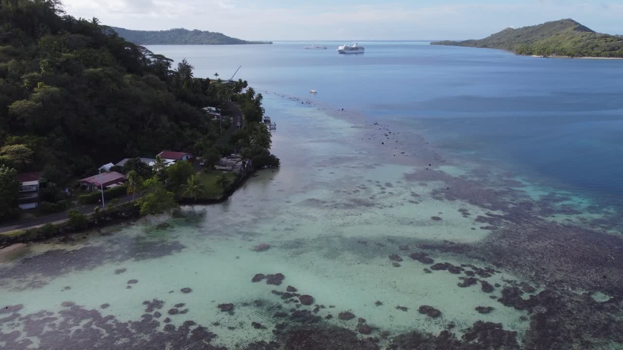 Bora Bora coast road aerial reveals cruise ship at anchor in lagoon