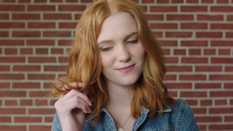 portrait of attractive flirty red head woman smiling playful shy wearing denim jacket