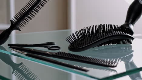 professional hair styling tools on a glass table